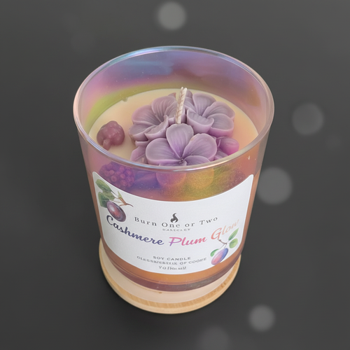 Cashmere Plum Glow Soy Candle with purple flower wax toppers in iridescent rainbow jar